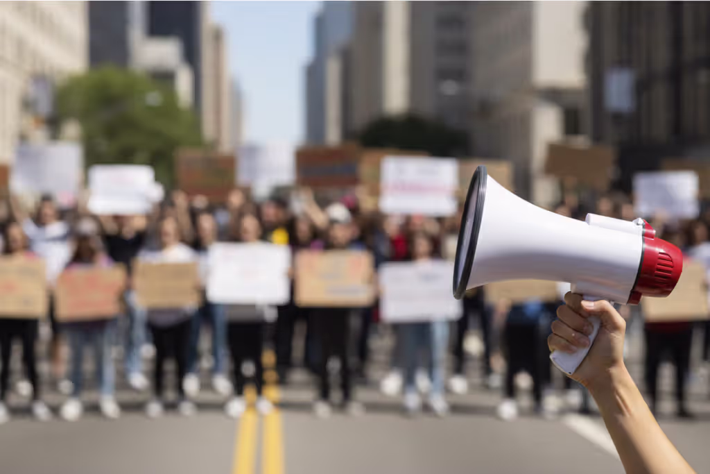 Peaceful protest scene with blurred signs and a megaphone in the foreground