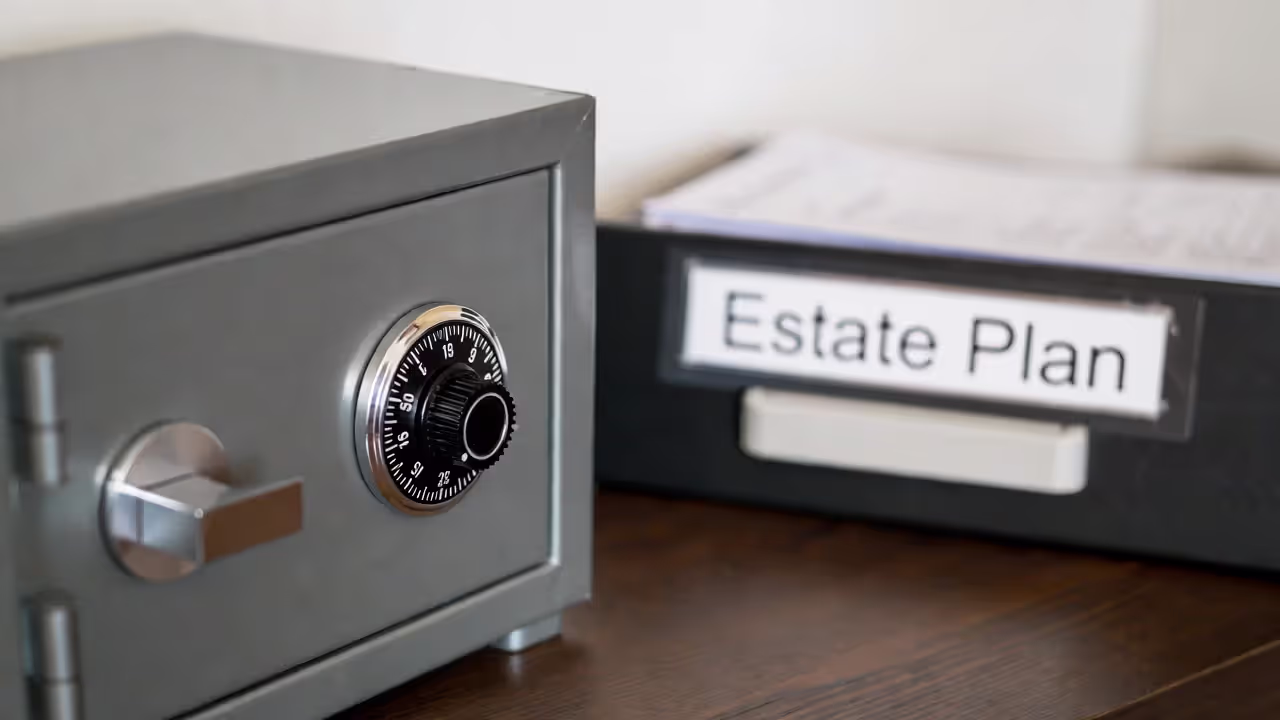 Home safe with an estate plan folder nearby, text blurred